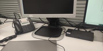 Picture of a desktop computer with a laptop charging on the table 