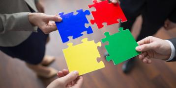 People holding puzzle pieces People holding puzzle pieces