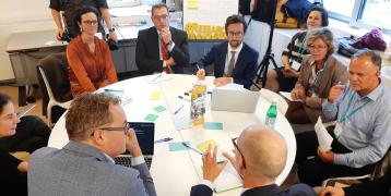 People sitting and discussing around a round table