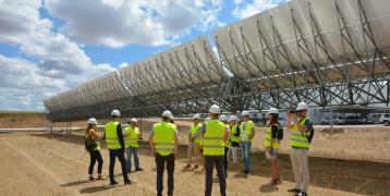 People talking behand Solar Panels