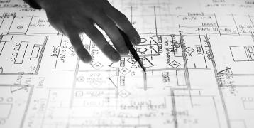 Person drawing architecture plan Person drawing architecture plan