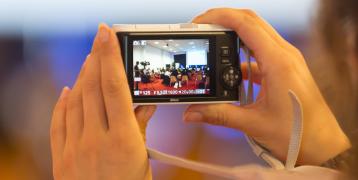 Person taking photo during event Person taking photo during event