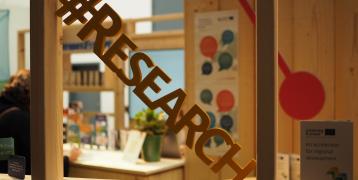 #Research The word research in wood placed in front of a window