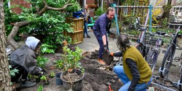 People taking out pavement tiles to green their street