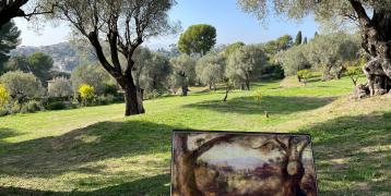 Lush green landscape with a painting of the landscape