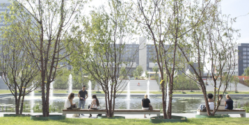 View of people sitting in front of a fountain View of people sitting in front of a fountain