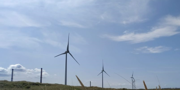 Wind energy turbines with a cloudy blue sky Wind energy turbines with a cloudy blue sky