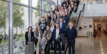 About 30 people posing on a staircase during a study visit