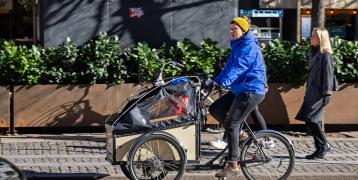 Women cycling on cargo bike in autumn/winter