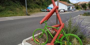 Parked bicycle next to a road Parked bicycle next to a road