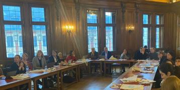 Experts and stakeholders at a large meeting table